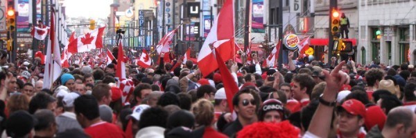 Crowd celebrating on Granville Street and Robson Street in downtown Vancouver following the Men's Hockey Final between Canada and the United States during the 2010 Vancouver Winter Olympic Games.