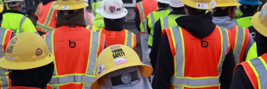 A group of workers wearing safety gear