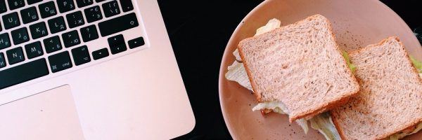 laptop with a sandwich plate near it