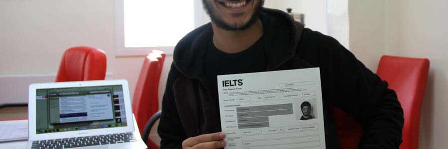 Man smiling and showing IELTS scores
