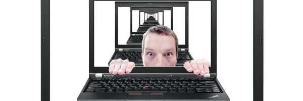 Peeping man on laptop screen
