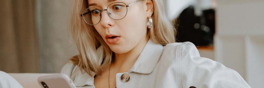 Lady with surprised face looking at her smartphone