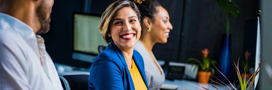 Woman smiling at co-worker