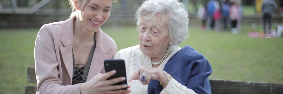 Older lady learning how to use a mobile phone