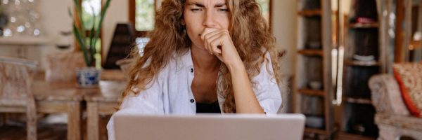 Woman looking at laptop seriously